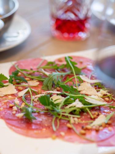 a plate with a pizza with greens on it at Radisson Blu Hotel, St. Gallen in St. Gallen