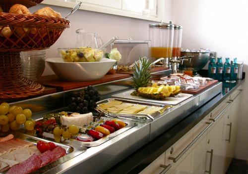 a buffet with many different types of food on it at Hotel Bonjour in Bad Soden am Taunus