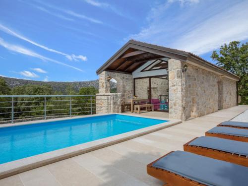 an outdoor swimming pool with a gazebo at Holiday Home Villa Matija by Interhome in Drivenik