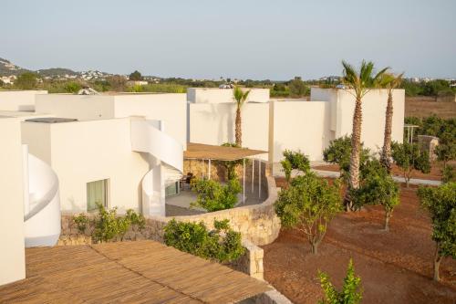 an aerial view of a white house with palm trees at Can Jaume by Ocean Drive in Ibiza Town