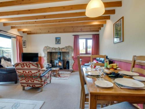 a living room with a table and a fireplace at Holiday Home Penrhy by Interhome in Devils Bridge