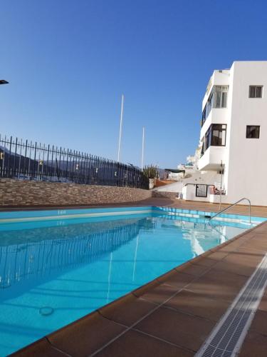 een zwembad voor een gebouw bij Apartamento Sunny Holidays in Puerto Rico de Gran Canaria