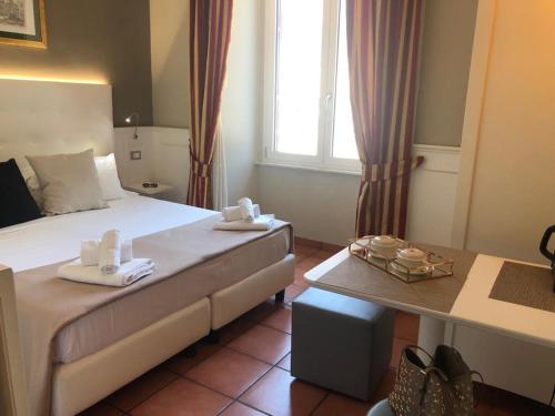 a hotel room with a bed with towels on it at 207 Inn in Rome
