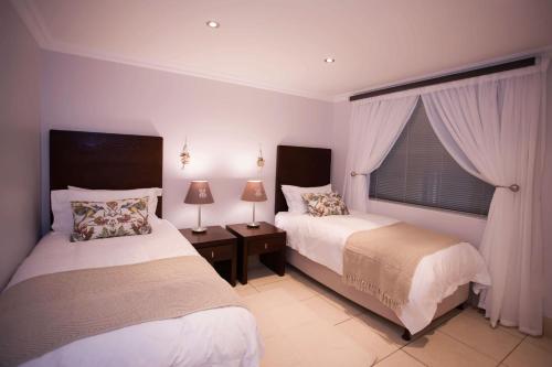 a bedroom with two beds and a window at Nautica 503 in Mossel Bay