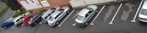a group of cars parked in a parking lot at Hotel New in Baia Mare
