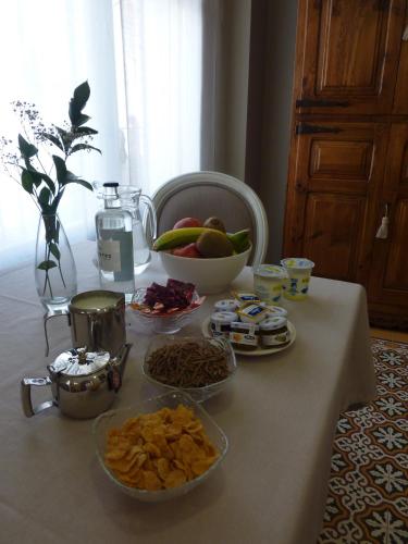 a table with bowls of food and a bowl of fruit at Hotel Castillo de Alquézar in Alquézar