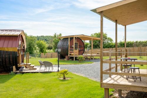 a garden with a circular house with a wooden structure at Les "JOLY" Foudres in Vaudelnay