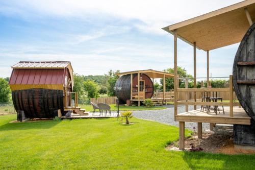 a garden with two houses and a shed at Les "JOLY" Foudres in Vaudelnay