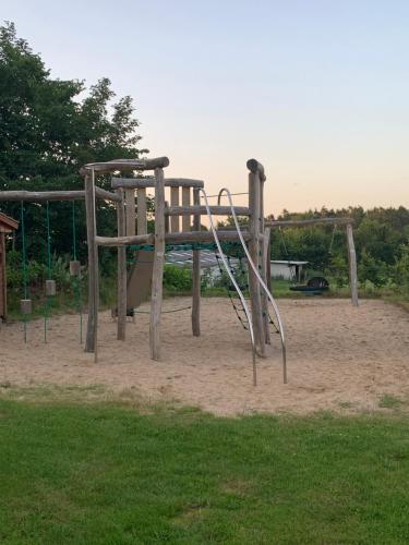a playground with a slide in a park at Billund Farm Holiday in Billund