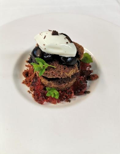a dessert on a white plate with cream on top at Radisson Blu Hotel, St. Gallen in St. Gallen