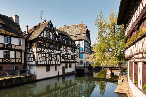 a group of buildings next to a river at Pavillon REGENT PETITE FRANCE in Strasbourg