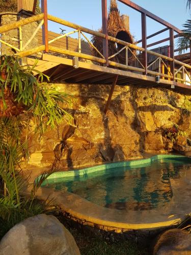 a bridge over a pool of water with a bridge at Dazk Golden Estate in Ribeira Brava