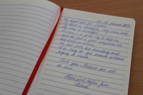 an open notebook with handwriting on the pages at Funchal Window by Homie in Funchal