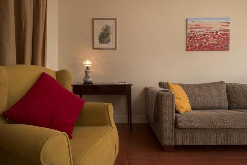 a living room with two chairs and a table at Funchal Window by Homie in Funchal