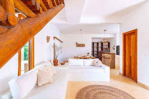 a living room with a white couch and a table at CasaLô Hotel in Jericoacoara