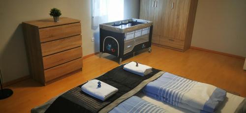 a bedroom with a large bed and a dresser at Strigonia Apartman in Esztergom