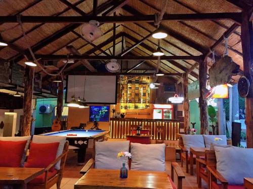 a restaurant with tables and chairs and a bar at LANGCHIA HOME in Phu Quoc