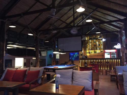 a bar with couches and a table and a pool table at LANGCHIA HOME in Phu Quoc
