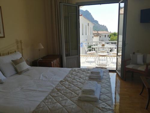 a bedroom with a large bed with towels on it at New Garden's House (120m2) in Leonidion