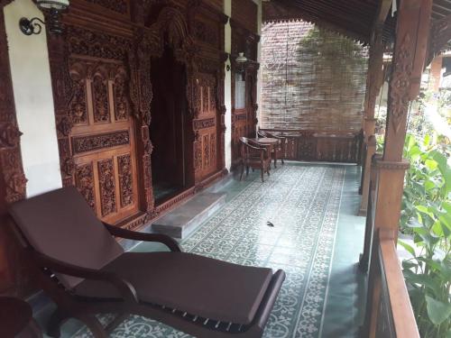an empty room with a chair and a table at Shanti Natural Panorama View Hotel in Singaraja