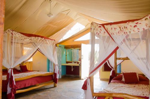 a bedroom with two bunk beds in a room at Maneaters in Tsavo