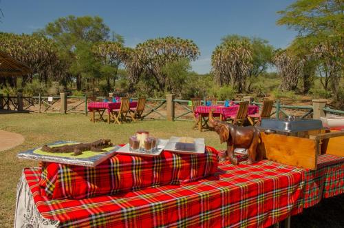 a table with a plaid table cloth with a horse on it at Maneaters in Tsavo