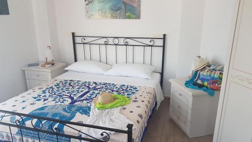 a bedroom with a bed with a blue and white comforter at La Porta dell'Alcantara in Gaggi