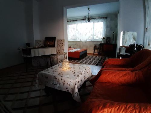 a living room with a table and a couch at Малко oазисче in Sofia