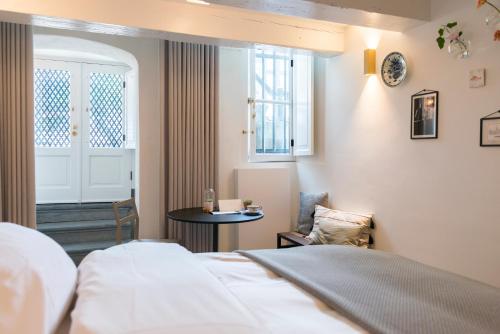 a hotel room with a bed and a window at Milkhouse Luxury Stay Amsterdam in Amsterdam