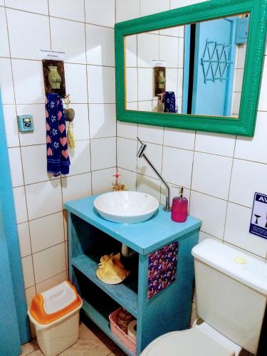 a bathroom with a sink and a toilet at CasaHostel Floresce in Praia do Rosa