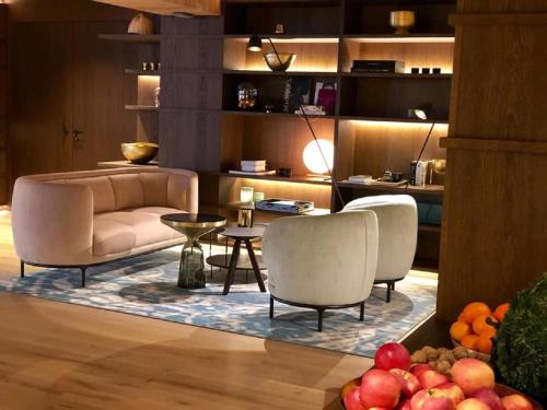 a living room with two chairs and a couch at Entners am See in Pertisau