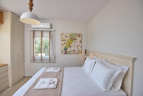 Ένα ή περισσότερα κρεβάτια σε δωμάτιο στο Aegean Suites