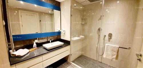 a bathroom with a sink and a shower with a mirror at Taksim leylak suite in Istanbul