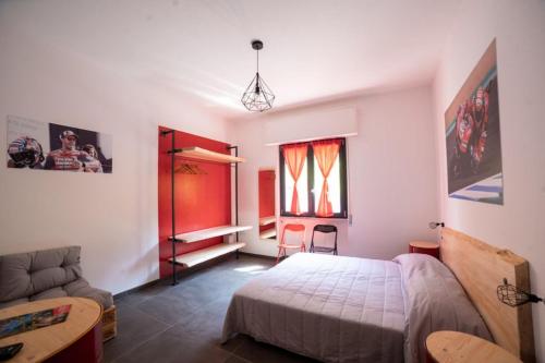 um quarto com uma cama e um sofá em Italian Piston House Sport Moto Rent em Millesimo