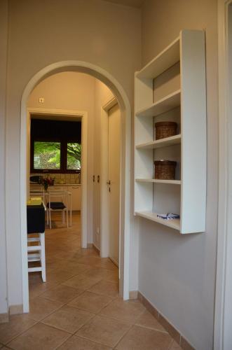 a hallway with an archway in a home with a table at Villa Cristina in Vezzo
