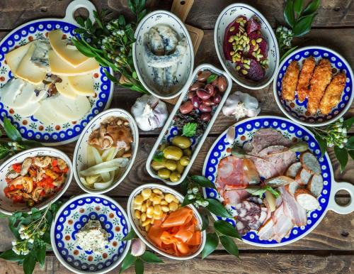 a table topped with bowls of different types of food at Hotel Fado Spa & Restaurant in Świdnica