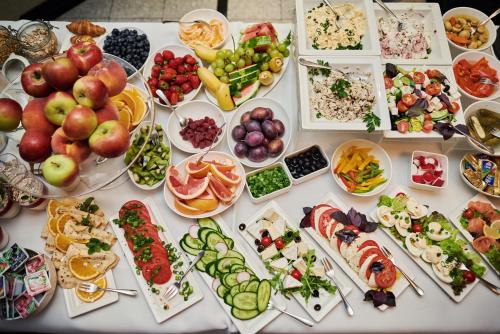 a table filled with lots of different types of food at Hotel Fado Spa & Restaurant in Świdnica