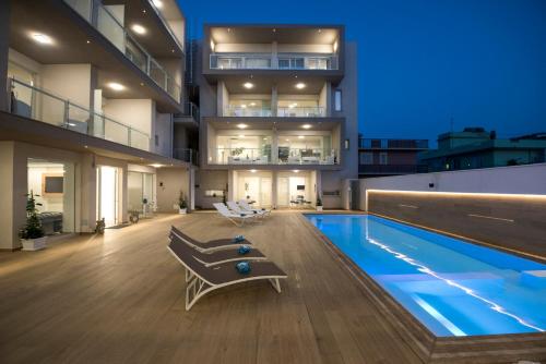 a house with a swimming pool and a building at Candiano Palace in Portopalo