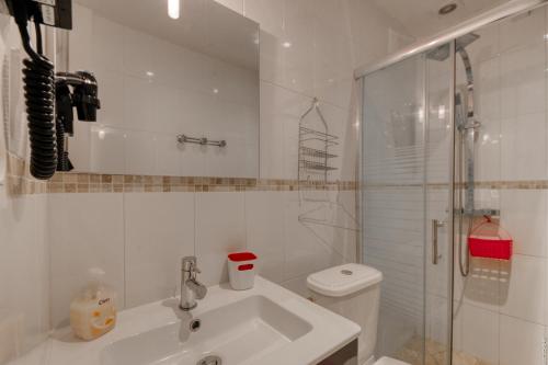 a bathroom with a sink and a shower and a toilet at Crew Lighthouse in Antibes