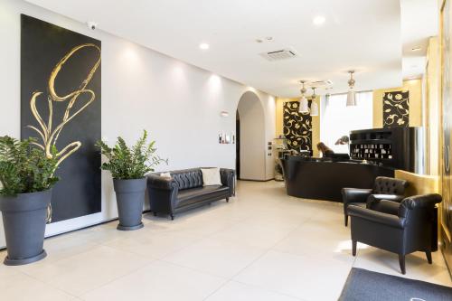 a salon with black chairs and a waiting room at Palazzo Salgar in Naples