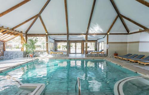 a large swimming pool in a building with a large ceiling at San Francisco Lodge & Spa in Los Andes