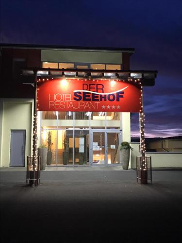 a sign in front of a hot store with lights at Der Seehof in Heimbach