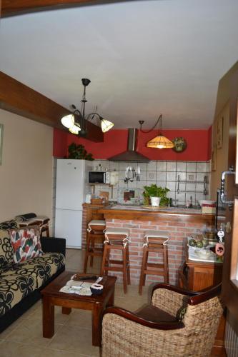 a living room with a couch and a kitchen at El Rincón del Oteru in Llanes
