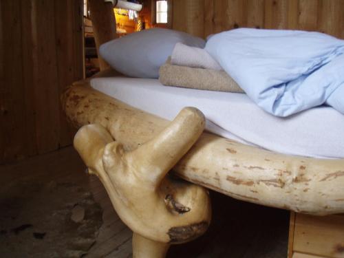 a wooden leg and foot of a bed with a mushroom at Engholm Husky Design Lodge in Karasjok