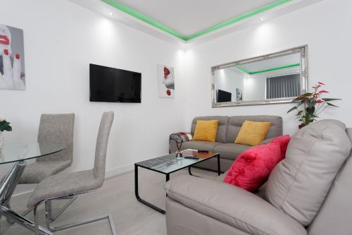 a living room with a couch and a table at Burton House in Leeds