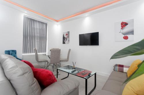 a living room with a couch and a table at Burton House in Leeds