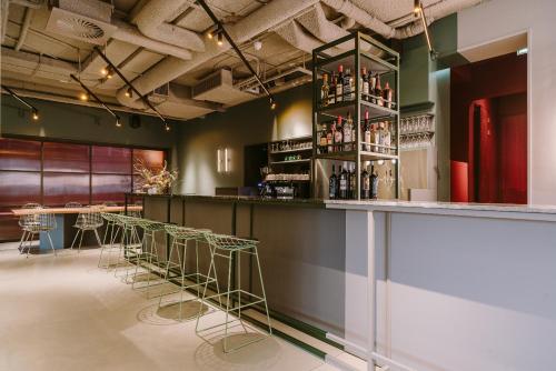 
a kitchen with a row of chairs and a bar at Supernova Hotel in Rotterdam
