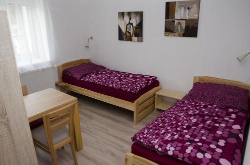 a small room with two beds and a table and a table sidx sidx at Ubytování Bor in Bor