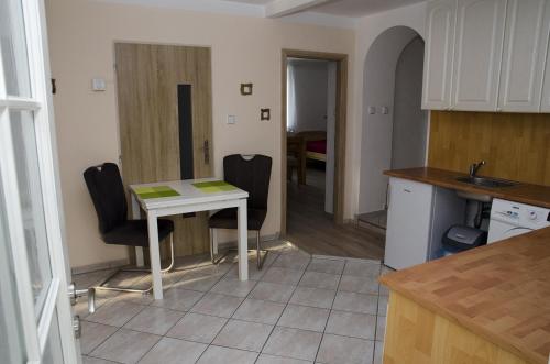 a kitchen with a table and chairs in a kitchen at Ubytování Bor in Bor