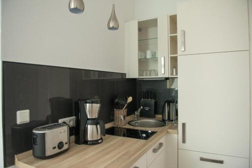 a kitchen with a counter with a coffee maker on it at Bootshaus Appartements in Cuxhaven